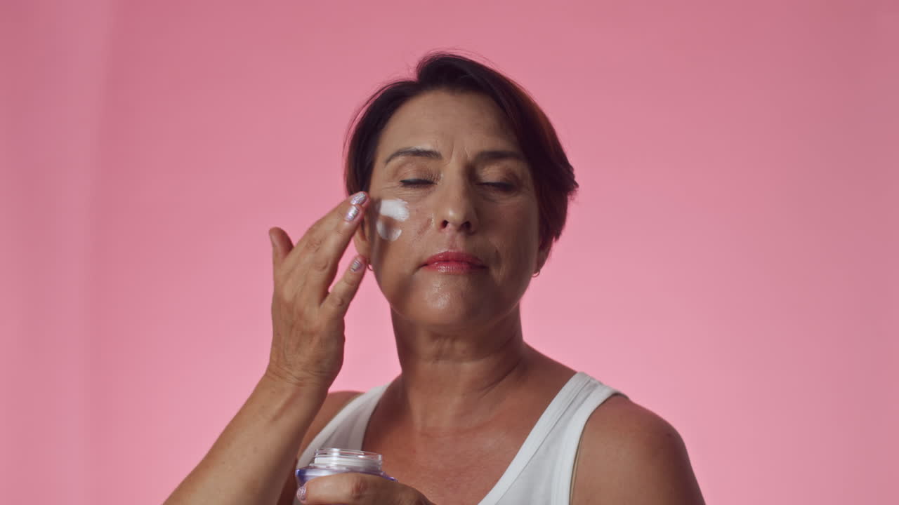 Mature Woman Applying Anti-age Facial Cream