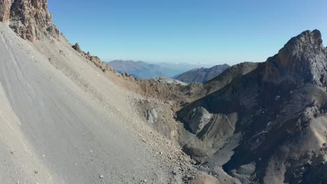 drone-flying-above-the-mountains,-forward-movement-passing-a-peak