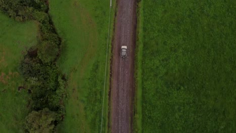 topview aerial of a car driving through machachi nature area, ecuador