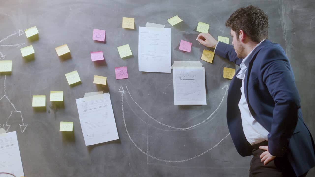 Young businessman in suit working in boardroom