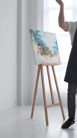 a young artist at work he works with inspiration paints a picture happy to do what he really likes - a young artist at work, he works with inspiration, paints a picture, happy to do what he really likes
