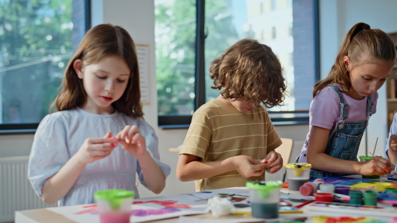 Kids engaged art activity at elementary school artclass closeup. Group children