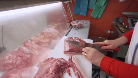 butcher cutting meat at a local market butchery