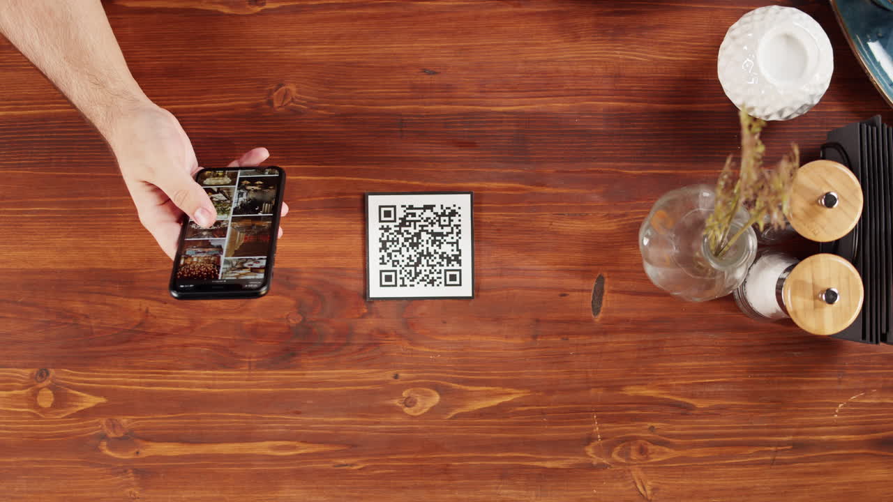 Hand Scanning QR Code with Smartphone for Digital Menu