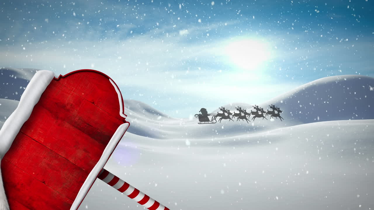 Animation of snow falling over santa hat over red signboard with copy space against winter landscape