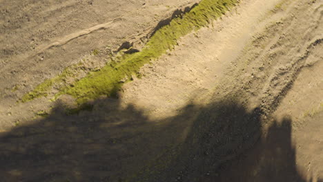 erosion of icelandic ridgeline in shadow of a mountian, spiral rise top-down view