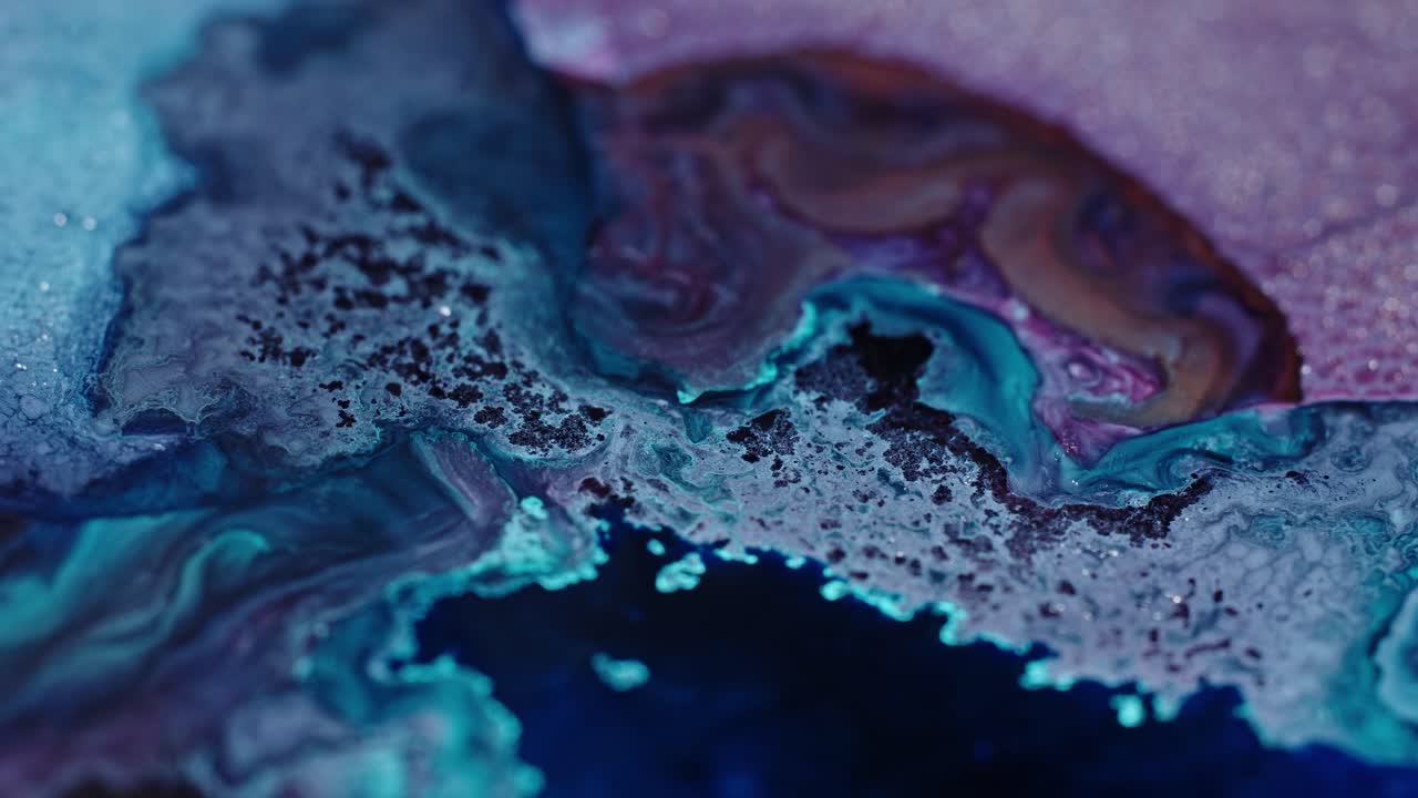Abstract swirls of blue and purple ink diffusing in water, creating an ethereal texture