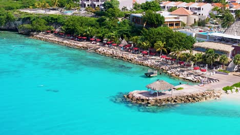 drone rises tilting down to establish karakter beach in curacao in early morning