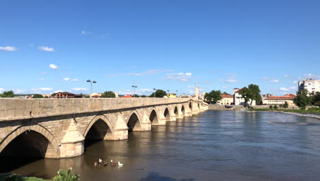 A-flock-of-geese-at-the-Old-Bridge-in-Svilengrad,-Bulgaria