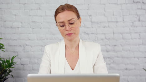 a tired writer working on a laptop