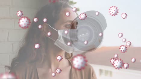 coronavirus cells spreading over woman with mask and security camera.