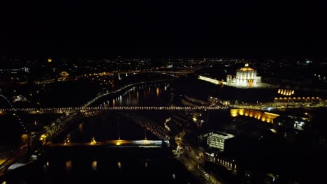 Nighttime-Drone-shots-of-the-Douro-River-in-the-heart-of-Porto,-Portugal