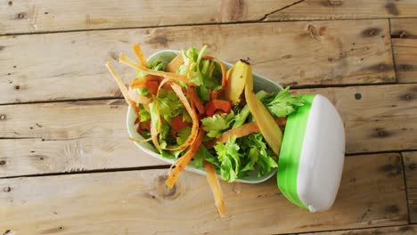 overhead video of organic fruit and vegetable waste in kitchen composting bin