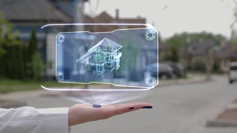mano femenina que muestra la casa holográfica