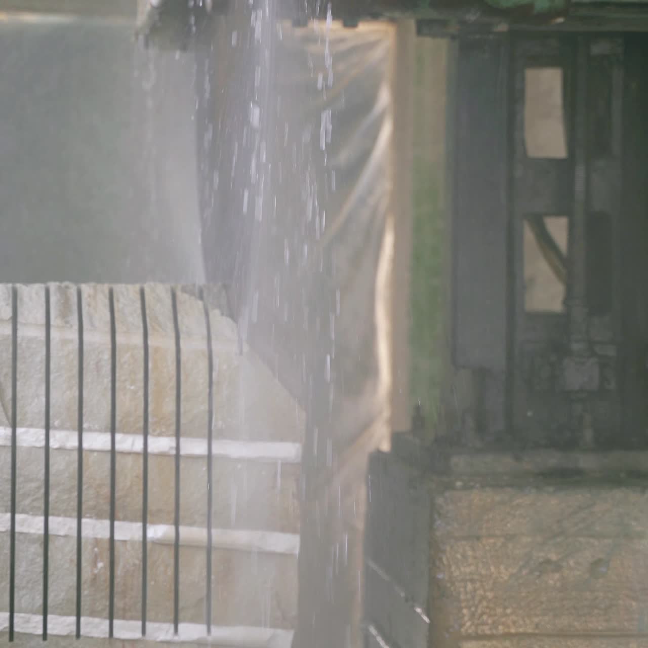 a professional machine is cutting a large stone in the building of a stone processing plant. Stone processing technology using water