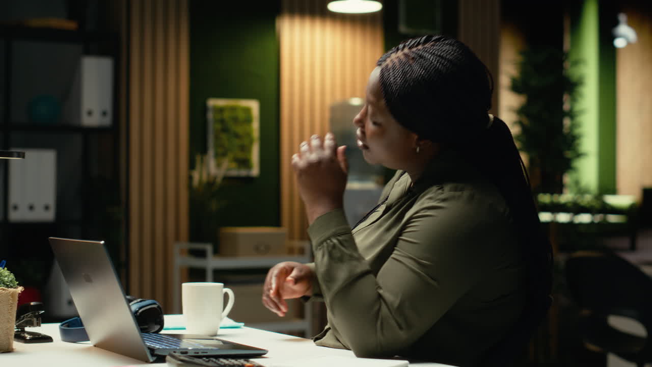 Black business employee realizing the night time alone in office
