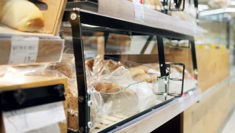 close up of a man grabbing a packed sandwich