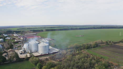 aerial view of a farm with grain silos and farmland