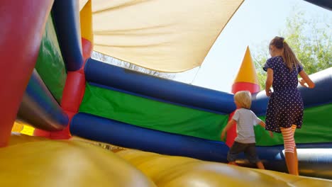 kids playing on the bouncing castle 4k