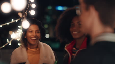 happy group of friends dancing to lively rooftop party music enjoying weekend celebration in urban city at night