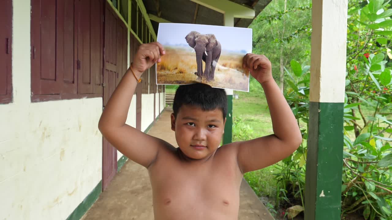 Kid Holding Picture Of Elephant