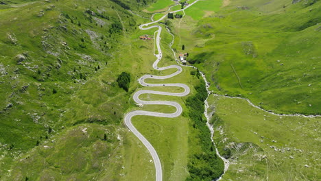 Aerial-View-Of-Vehicles-Driving-On-Julier-Pass-And-Gelgia-River-In-Summer-In-Switzerland