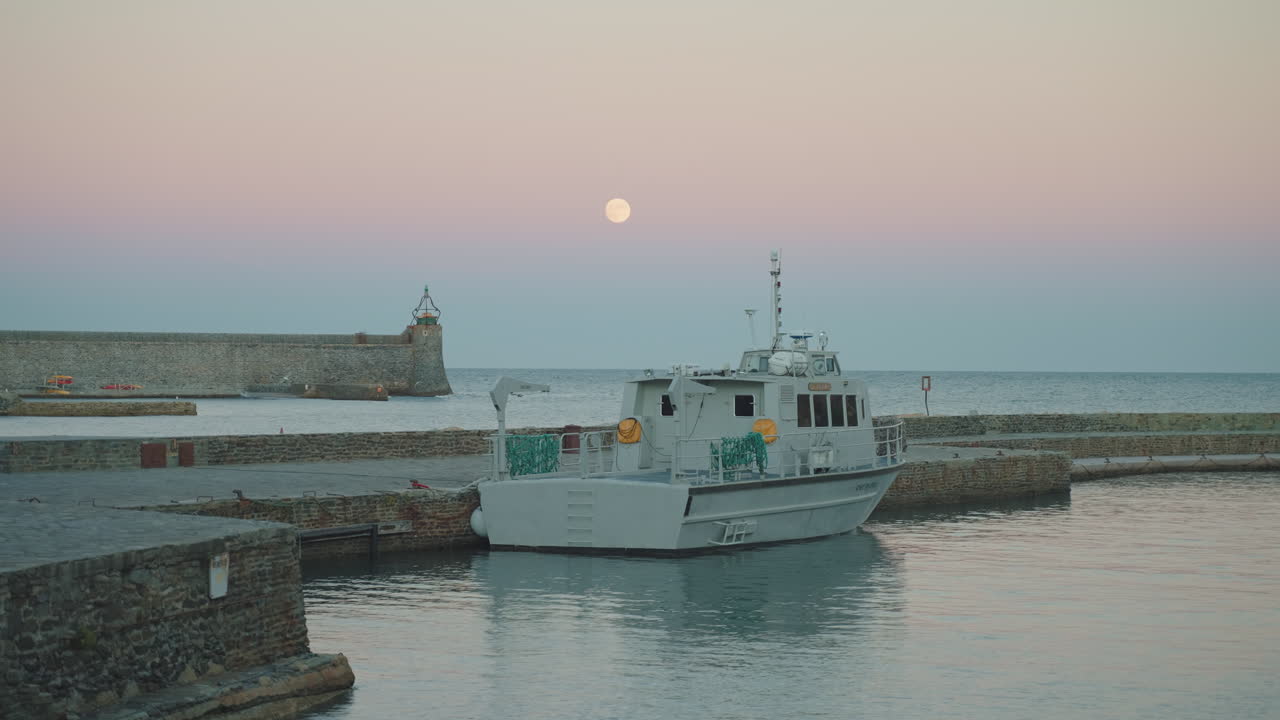Moonlit Collioure harbor, C&ocirc;te Vermeille, moored boat, serene vibe