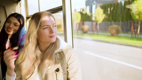 young woman looking out the window in the bus