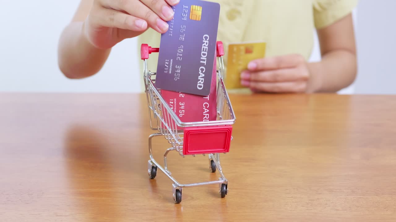 A person uses a credit card to shop showcasing modern consumer habits in a cozy home environment