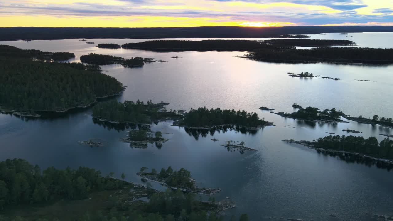 Swedish archipelago in aerial drone shot flying over water forest and islands
