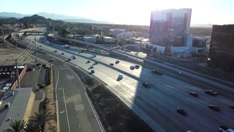aerial view of highway traffic and cityscape