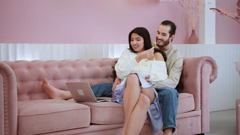 romantic couple eating popcorn