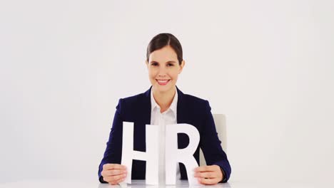 Businesswoman-holding-paper-cut-out-of-HR-sign