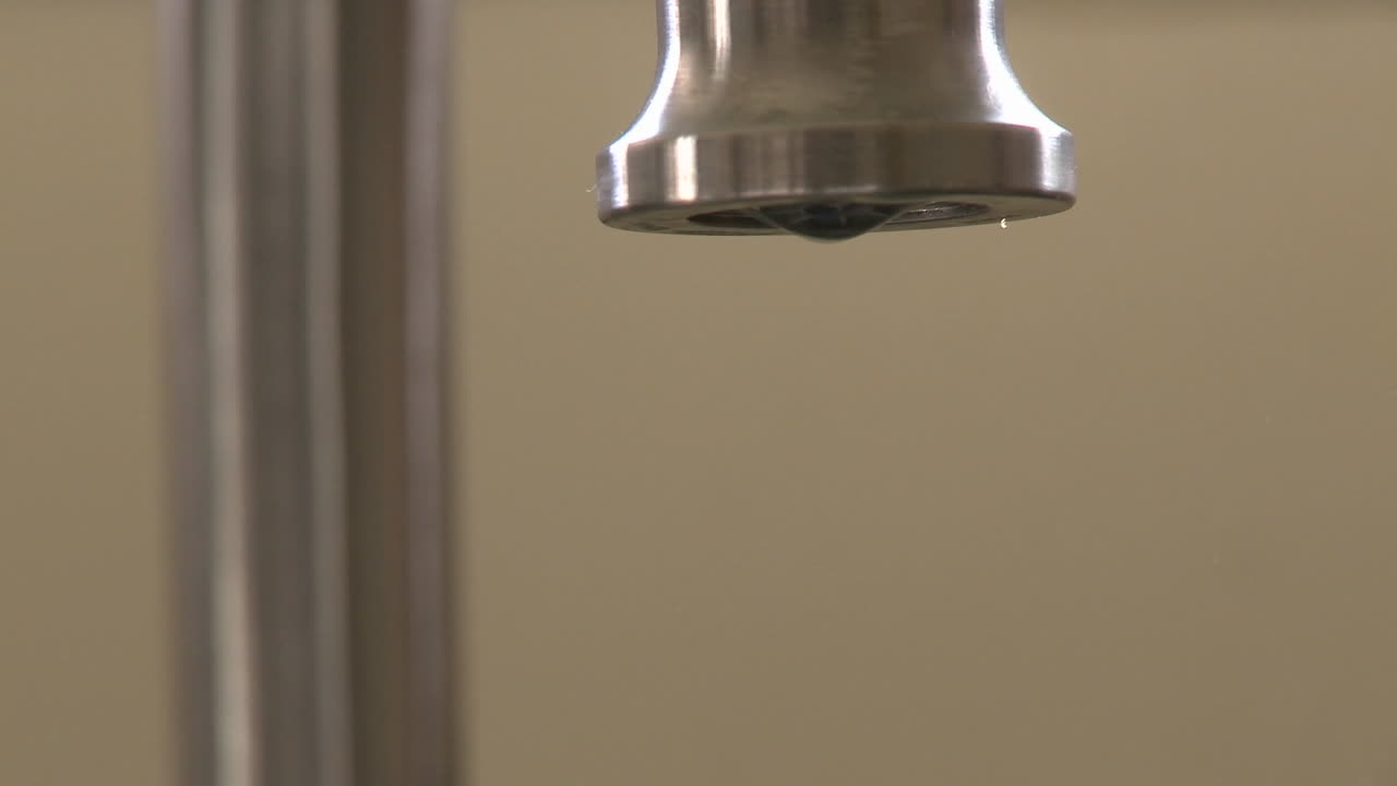 Close up of water dripping slow from a faucet in Oak View California