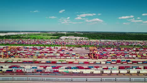 Massive orange gantry cranes amid a sea of colorful shipping containers