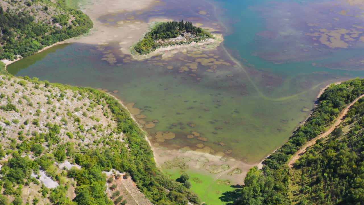 Galjipovac Blue Lake gives way to Prolosko Blato swamp area in Croatia, Aerial flyover view