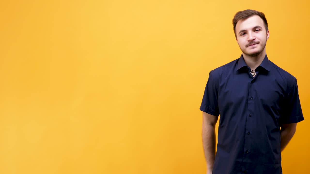 Portrait of a Smiling Man in Front of a Yellow Background