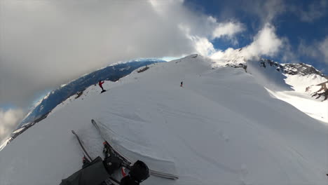 360 gopro view: a young ski freestyle athlete performs a backflip on swiss ski slopes in the alps