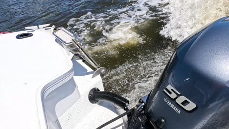 outboard motor propelling boat through ocean waves