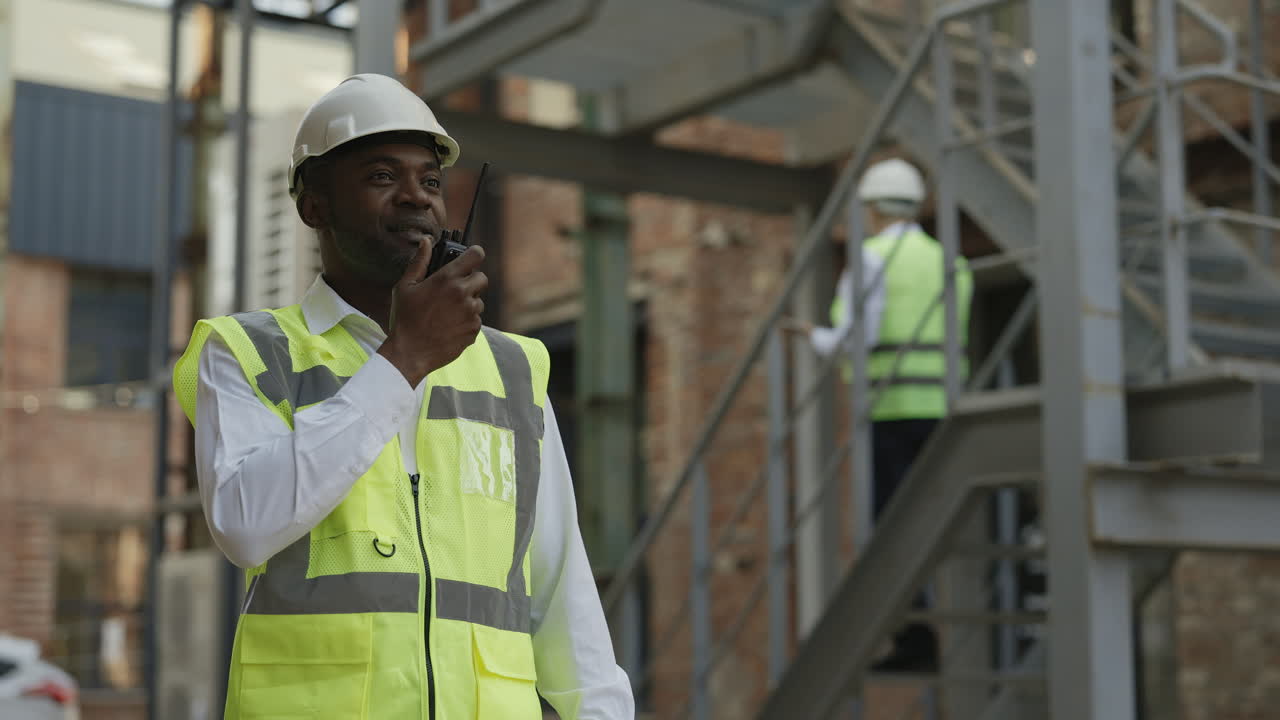 Construction Worker Communicating on Walkie-Talkie