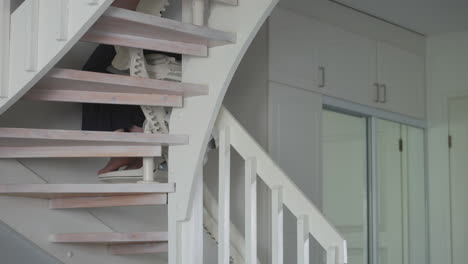 disabled adult moving between floors using handicap stair lift