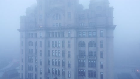 dense fog cover aerial view liverpool liver building in haunting thick gloomy weather visibility