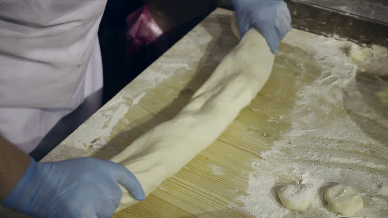 Making dough at kitchen. Chef hands kneading dough. Hands form raw dough