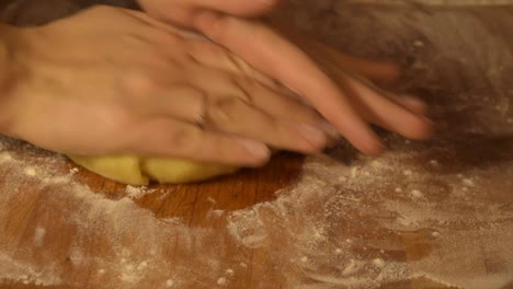 modelling cookie dough into sausage before cutting it in pieces