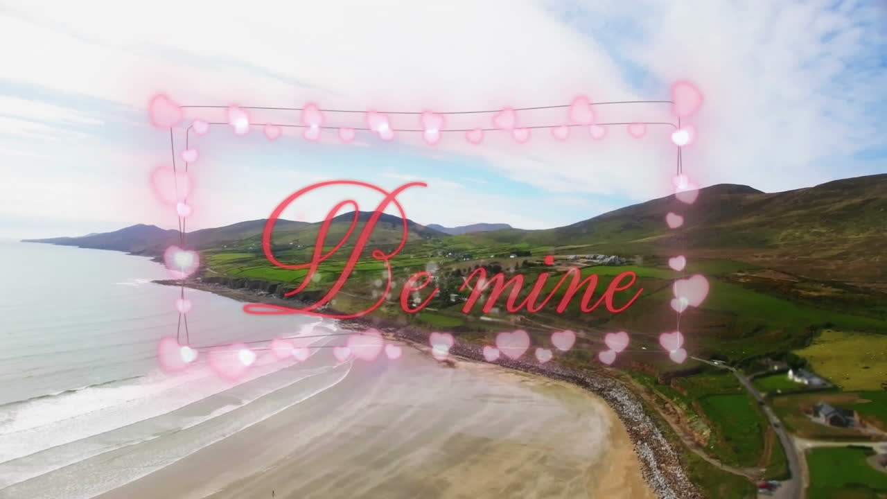 Be mine text with heart animation over coastal landscape and rolling hills