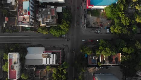 rising up from crossroad in chennai city, india, a few cars and som motorcycles passing by beneath