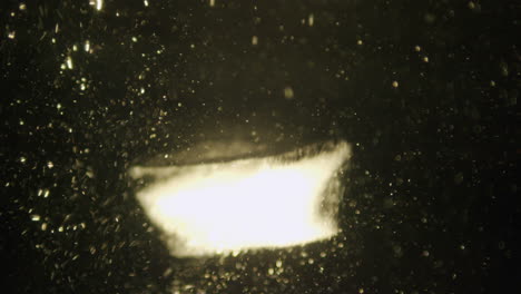 ice cube falling in water in slow motion.