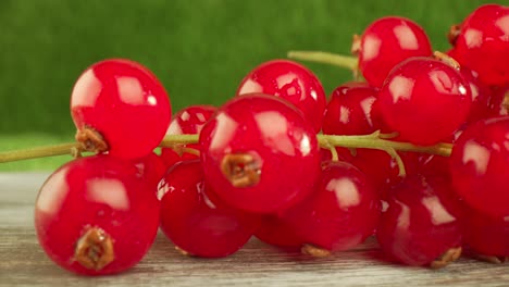 Super-close-macro-of-a-redcurrants-on-a-wooden-table.