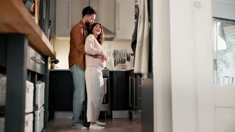 loving couple expecting a baby in their kitchen