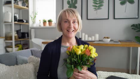 video portrait of senior woman with bouquet of flowers